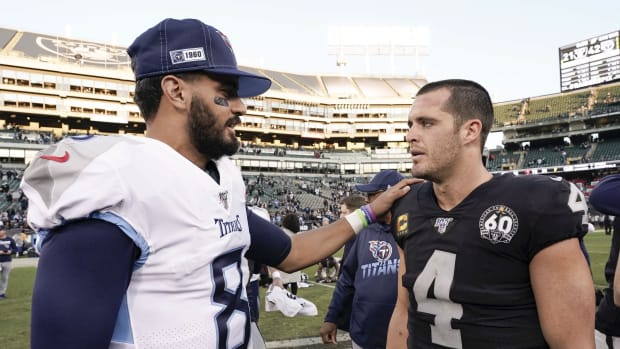 Tennessee Titans quarterback Marcus Mariota (8) speaks with Oakland Raiders quarterback Derek Carr (4) after the game at Oakland Coliseum.